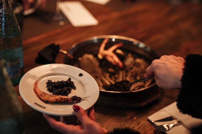 Barcelona: Guided Food Walking Tour with Tapas and Wine - Stop 2 on Carrer Ample: Patatas Bravas, Pimientos de Padrón, and Wine Pairing