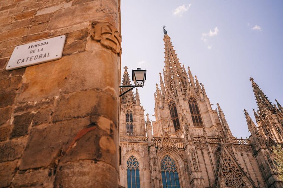 Barcelona: Guided Walking City Tour, Cable Car & Boat Ride - Entering the Gothic Quarter Toward Barcelona Cathedral