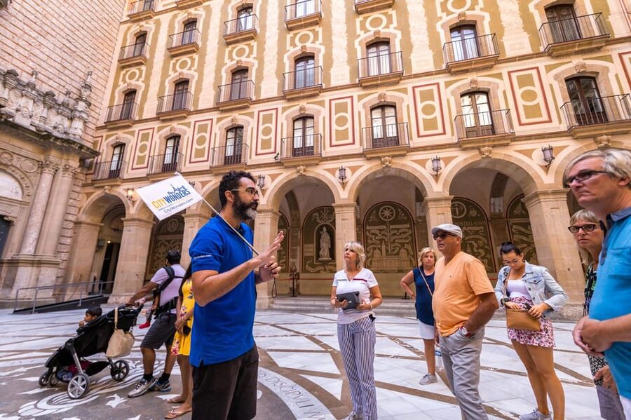 Barcelona: Montserrat Tour with Lunch & Wine Tasting Option - Montserrat monastery: guided first steps, basilica entry, and La Moreneta context