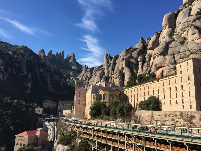 From Barcelona: Montserrat Monastery & Scenic Mountain Hike - Entering the Montserrat Monastery Complex and Seeing the Black Madonna